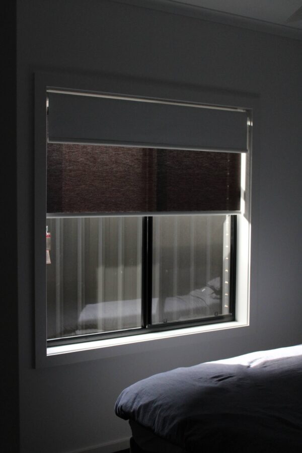 Dual Roller Blinds installed on a bedroom window, offering comfort and privacy.