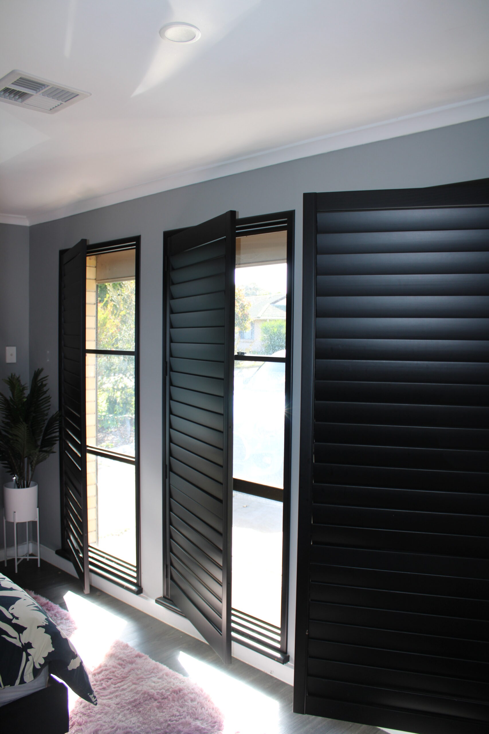 Black plantation shutters open